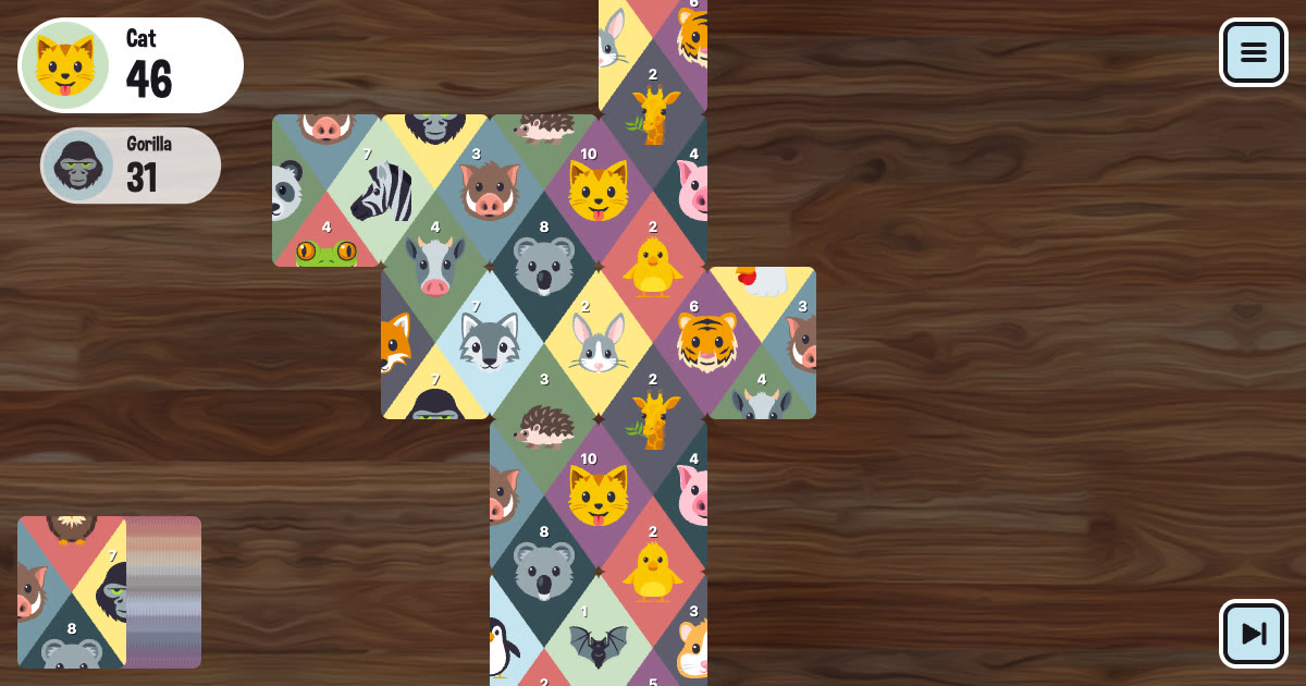 A game of Matchimals in progress: colorful diamond cards with animal faces connected across a wooden table
